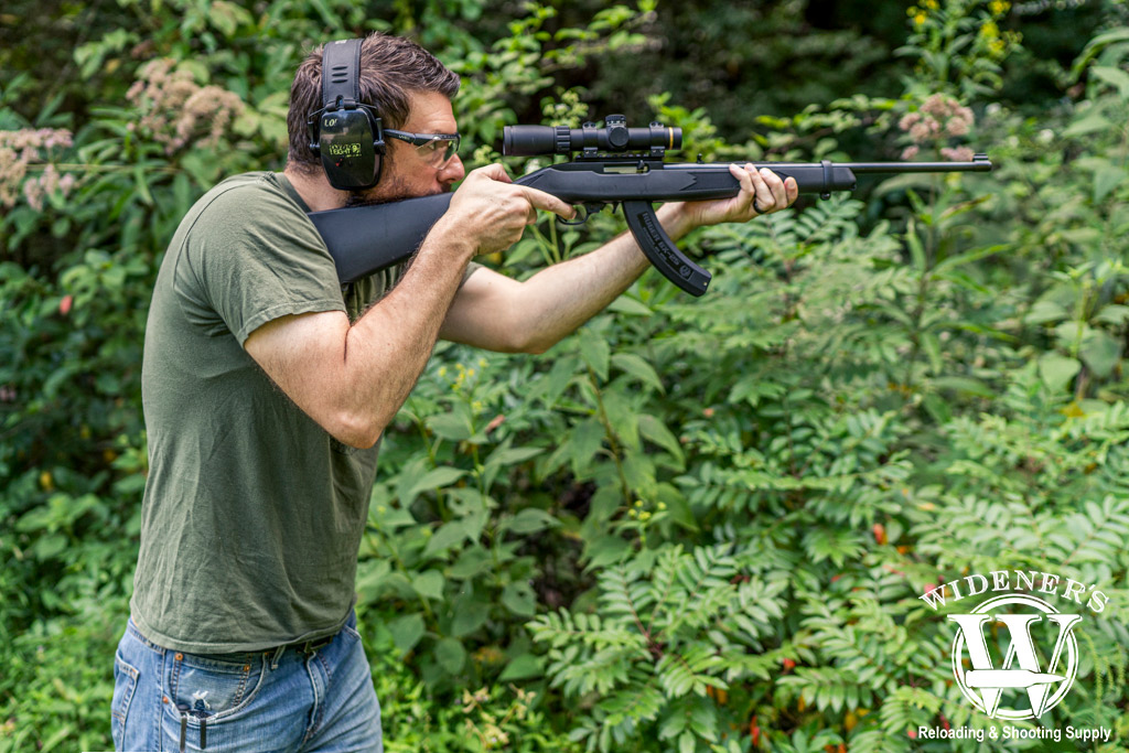 a photo of a man shooting a ruger 10/22 rimfire rifle